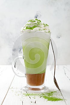 Matcha latte with salted caramel in tall glass