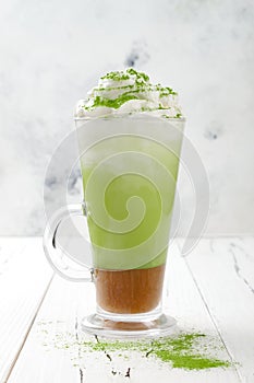 Matcha latte with salted caramel in tall glass