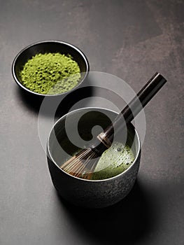 Matcha and matcha powder on dark background