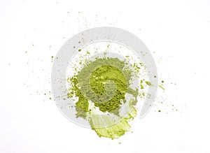 Matcha powder explosion on white background top view. Matcha is made of finely ground green tea powder. It`s very common in