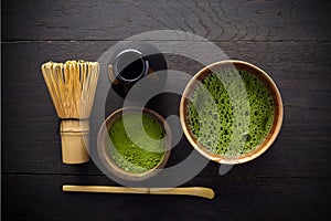 Matcha powder. Organic green matcha tea ceremony. Healthy drink. Traditional japanese drink on black wooden background