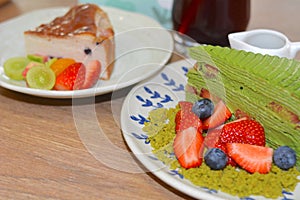 Matcha strawberry layer cake with fresh muscadines and blueberries, Basque cheesecake and fruit tea