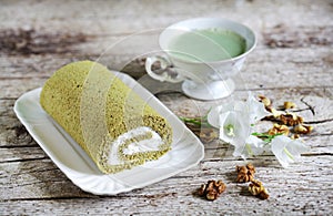 Matcha swiss roll roly poly with whipped cream and walnuts, green tea