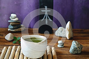 Matcha tea in a composition with a garden of stones