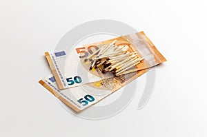 Matches are on 50 euro banknotes, made of wood, production of matchsticks, white background