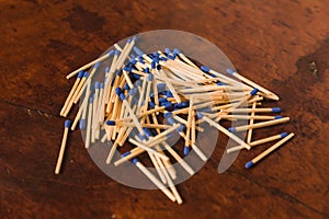 Matches with the match part or blue head, grouped on a wooden table