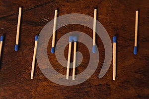 Matches with the match part or blue head, grouped on a wooden table. 5