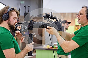 Matching cameras on the set. Behind the scenes of movie shooting or video production and film crew team with camera