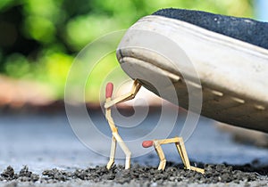 Matchstick art photography used matchsticks to create character. One man is helping another helpless. Helping concept.