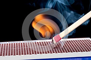 Matchstick on fire photo