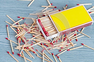 Matchstick out of matchbox on color wood