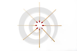 Matchsticks radially spaced on white