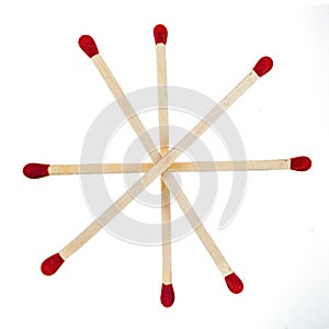 Matchsticks with red heads grouped in a star