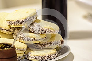 Mate and Delicious Argentinian and uruguayan cookies alfajores with cream on paper close-up on the table.