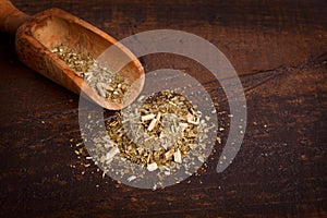 Mate with scoop on wooden background