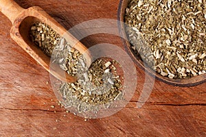 Mate with wooden scoop on wooden background photo