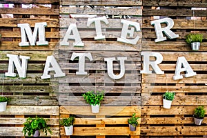 Mater natura mother nature text green thumb pallets wooden background