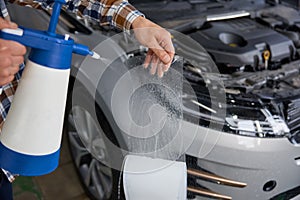 Mater spraying protective ppv film before covering car body or headlight