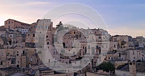 Matera holiday, summer, panorama of historic Matera stone with bell tower under sunset colorful sky, European Capital of Culture