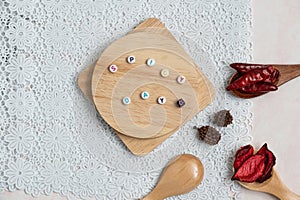 Material of wooden board with spicy day words and decorates with chilis and spices on white flower background