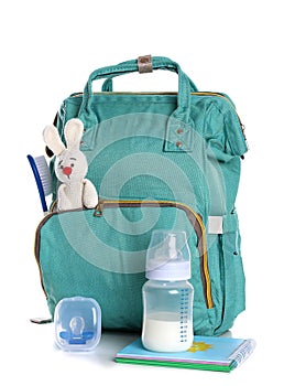Maternity backpack with baby accessories on white