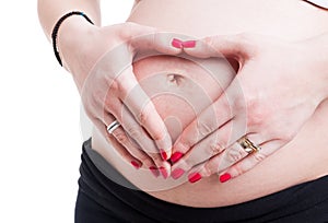 Maternity concept with pregnant woman with hands on her belly