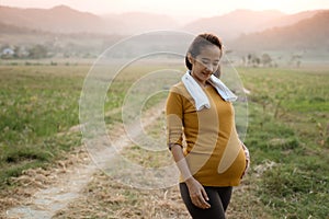 Maternity woman take a break after workout outdoor