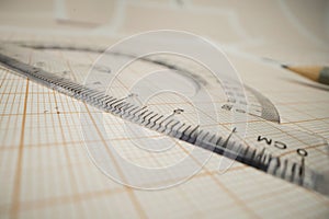 Math concept - macro of a pencil on a piece of paper with geometric measurement tool