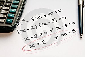 Math exercise with calculator and pen