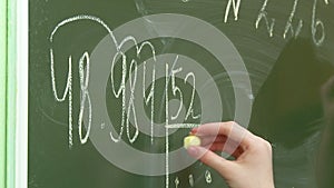 Math lesson at school children solve problems at the blackboard and at their desks