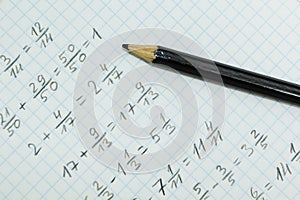 Math problems on graph paper with black pencil