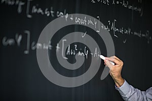 Math teacher by the blackboard during mathclass