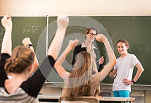 Math teacher standing in front of students who are well prepared