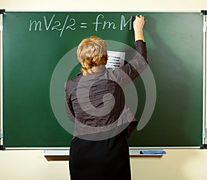 Math teacher writing formula