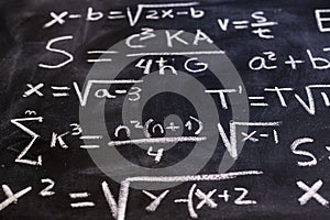 Mathematical equations and physics formulas handwritten on blackboard photo