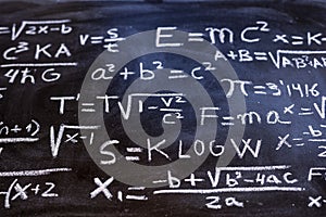 Mathematical equations and physics formulas handwritten on blackboard photo