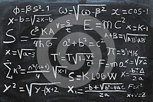 Mathematical equations and physics formulas handwritten on blackboard photo