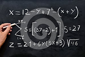 Mathematical equations written on a blackboard