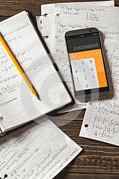 Mathematical equations written in a notebook. Calculator app.