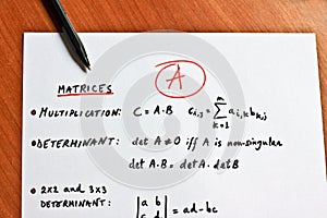 Mathematical formulas written on a white paper