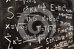 Mathematical equations and physics formulas handwritten on blackboard photo