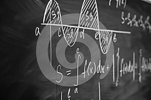 Mathematics function integra graph formulas on the chalkboard.