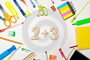 Mathematics. numbers 2 plus 3 on the school desk. concept of education. back to school. stationery. White background. stickers, co