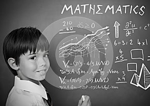 mathematics text and equations on blackboard with boy