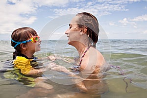 Mather and daughter playing in the sea