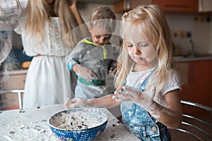 Mather daughter and son haveing fun on a kitchen