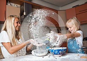 Mather and daughter throws flour in each other