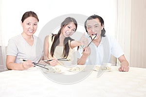 Mather and a young couple having dinner photo