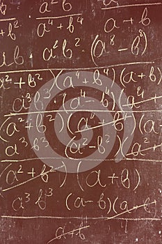 Maths formulas written by white chalk on the chalkboard background