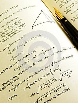 Maths reference book and pen